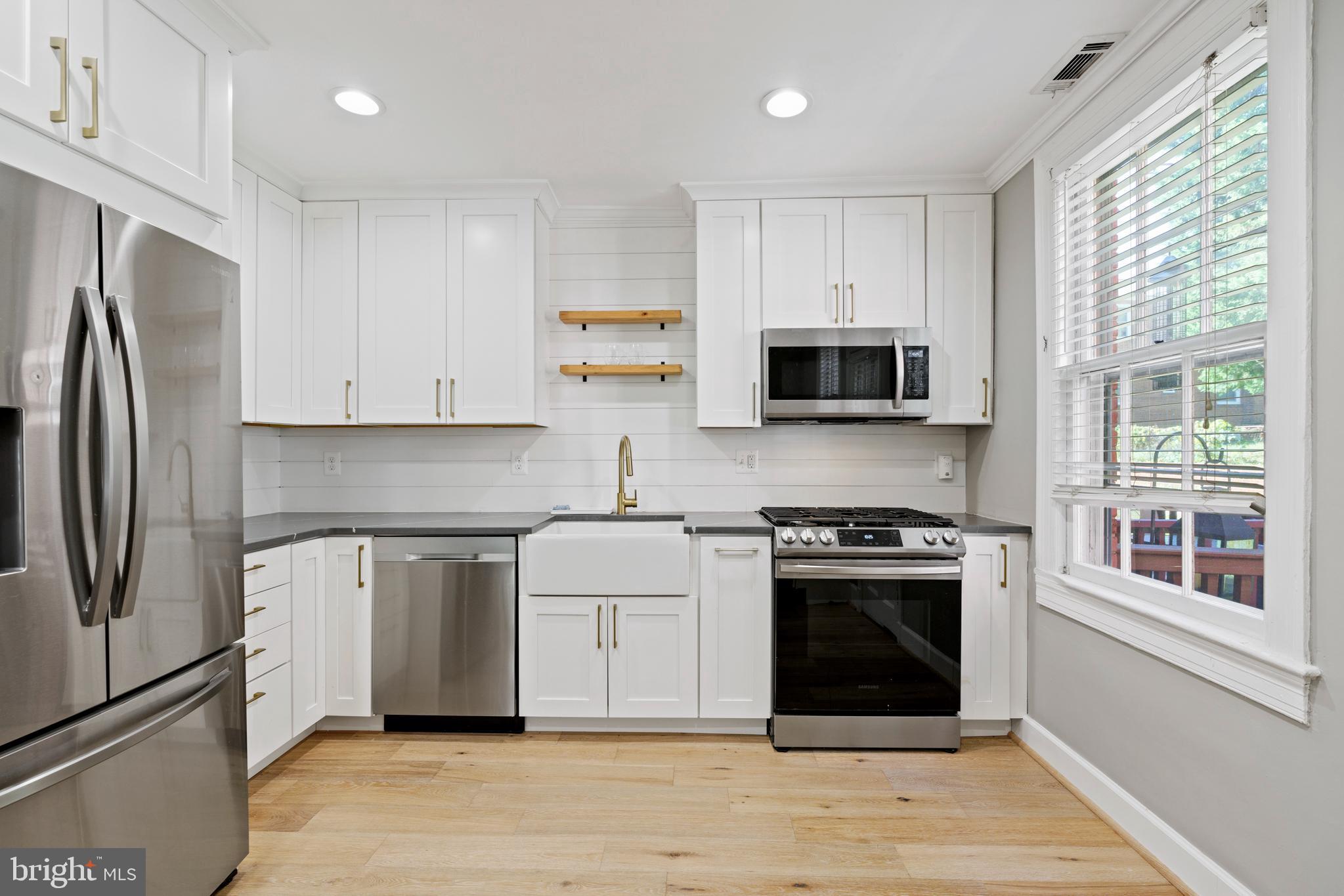1300 South Cleveland Street, Unit 363 Arlington, VA 22204 - Photo 14 of 37 a kitchen with stainless steel appliances granite countertop a stove a refrigerator and a microwave