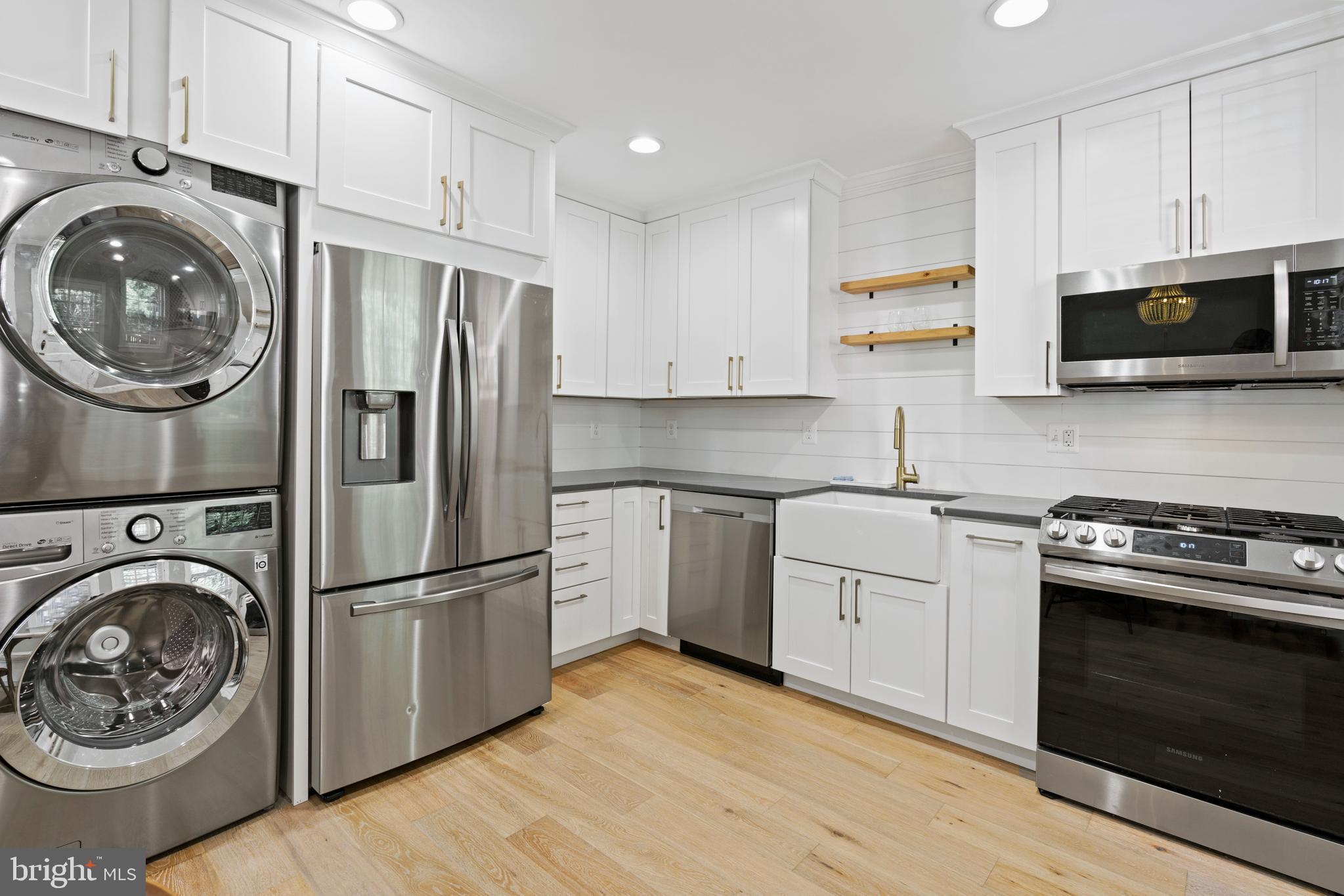 1300 South Cleveland Street, Unit 363 Arlington, VA 22204 - Photo 16 of 37 a kitchen with stainless steel appliances granite countertop a refrigerator a stove top oven a sink and cabinets