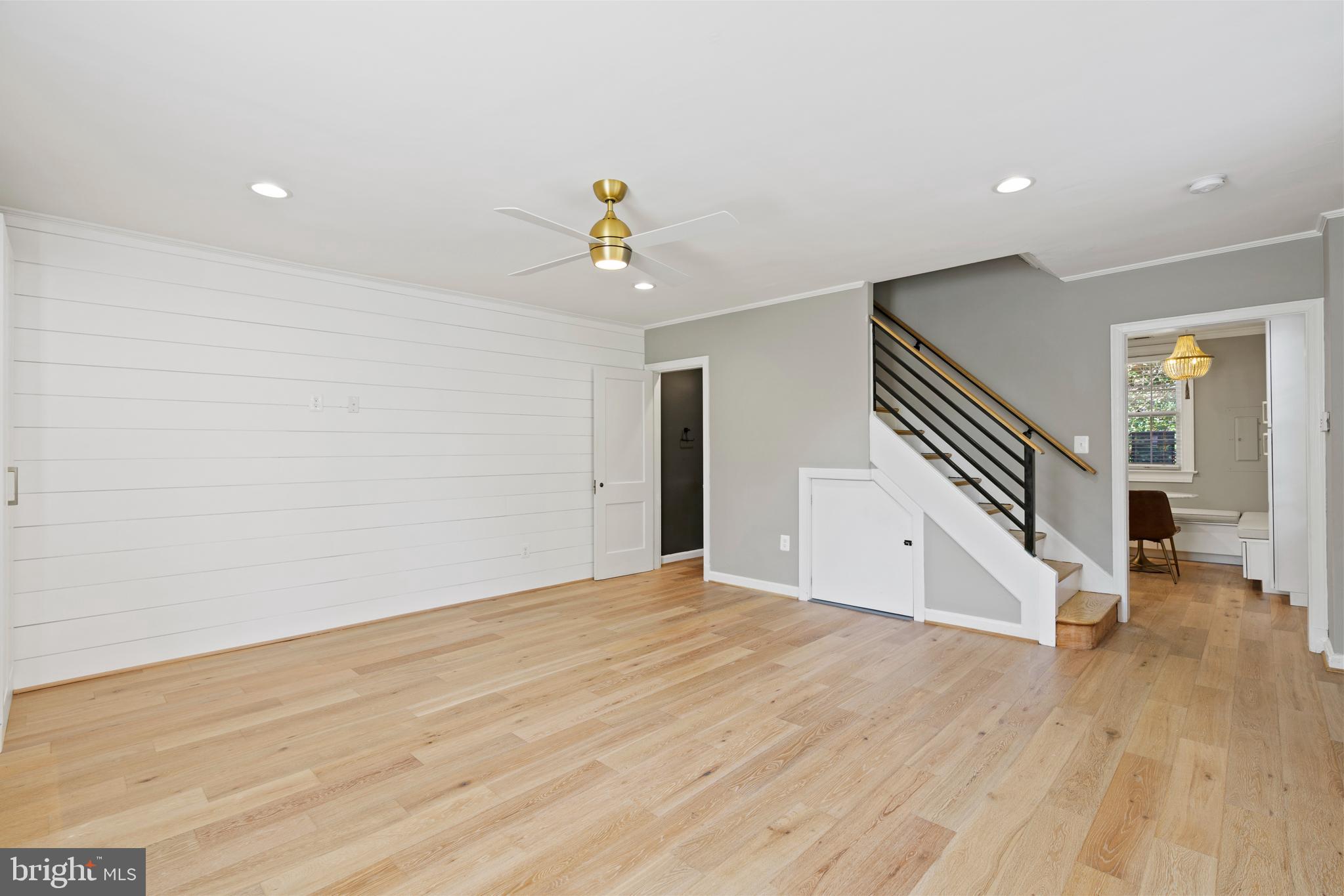 1300 South Cleveland Street, Unit 363 Arlington, VA 22204 - Photo 2 of 37 a view of an empty room with wooden floor and stairs