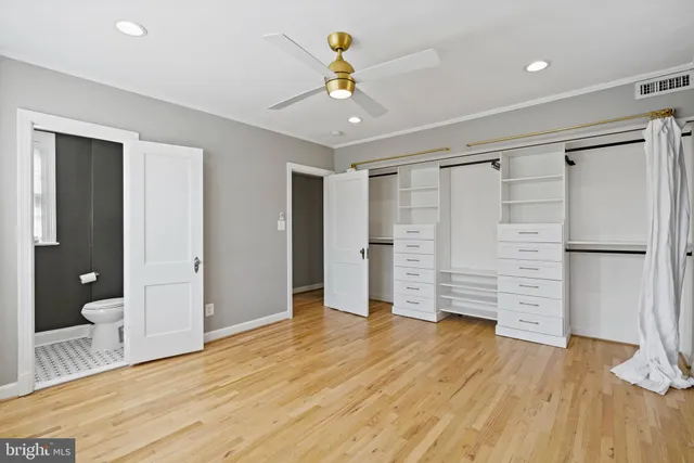 a view of an empty room with wooden floor and entryway