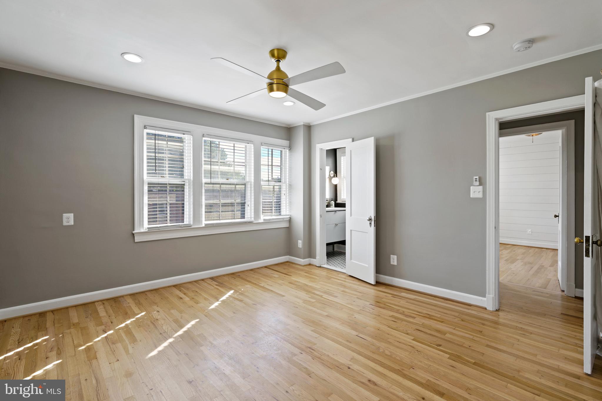 1300 South Cleveland Street, Unit 363 Arlington, VA 22204 - Photo 22 of 37 a view of an empty room with wooden floor and a window
