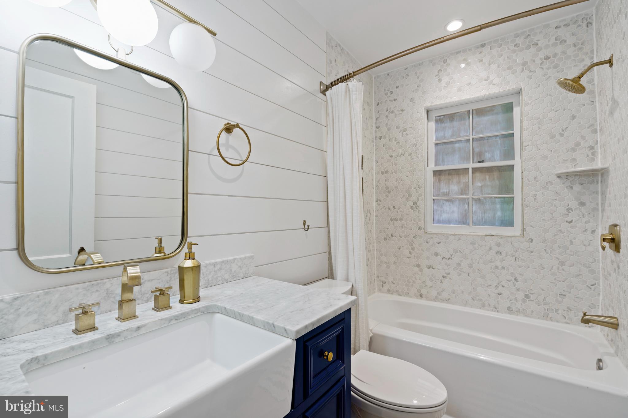 1300 South Cleveland Street, Unit 363 Arlington, VA 22204 - Photo 23 of 37 a bathroom with a granite countertop sink toilet and bathtub