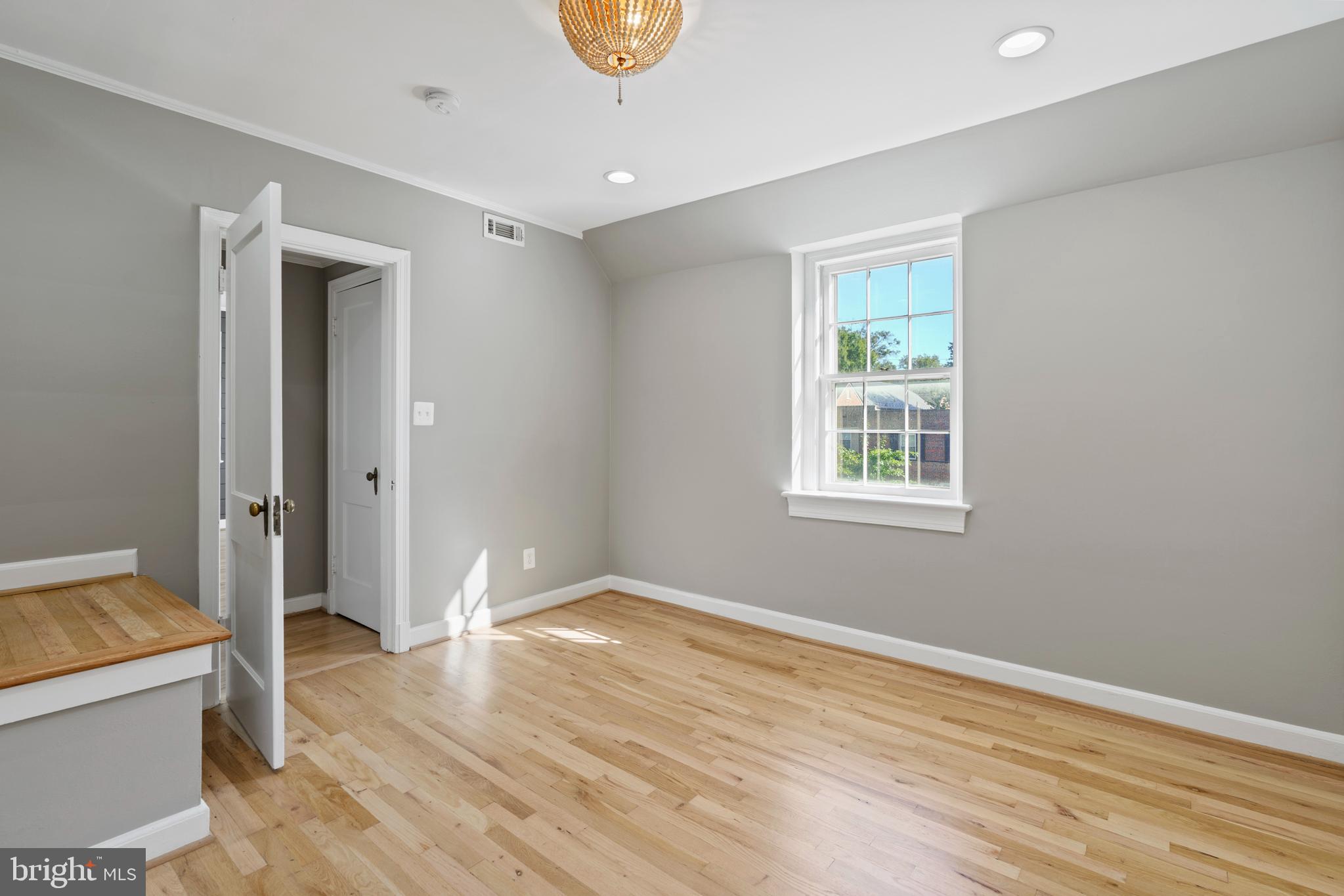 1300 South Cleveland Street, Unit 363 Arlington, VA 22204 - Photo 26 of 37 an empty room with wooden floor and windows