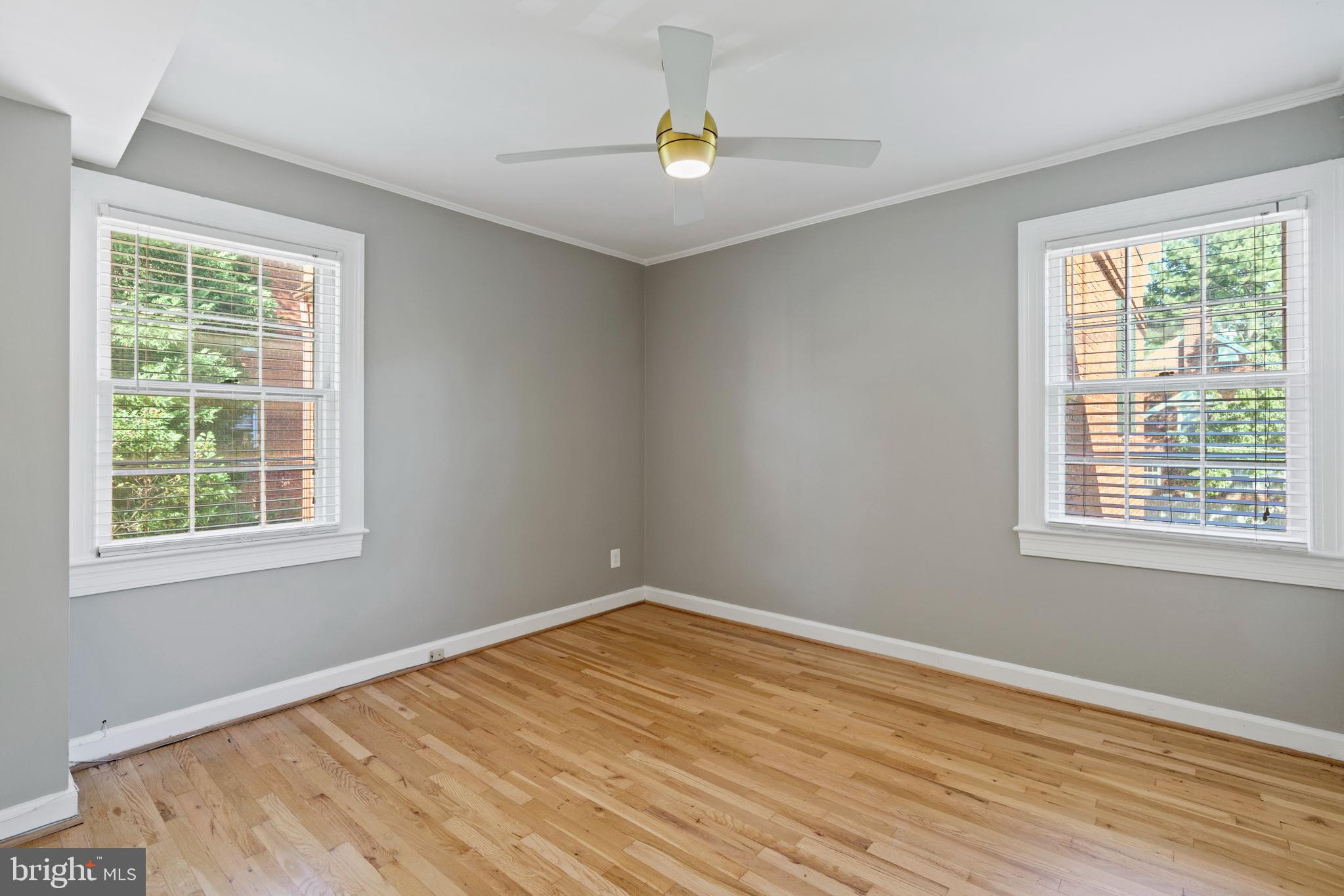 1300 South Cleveland Street, Unit 363 Arlington, VA 22204 - Photo 27 of 37 a view of empty room with wooden floor and fan