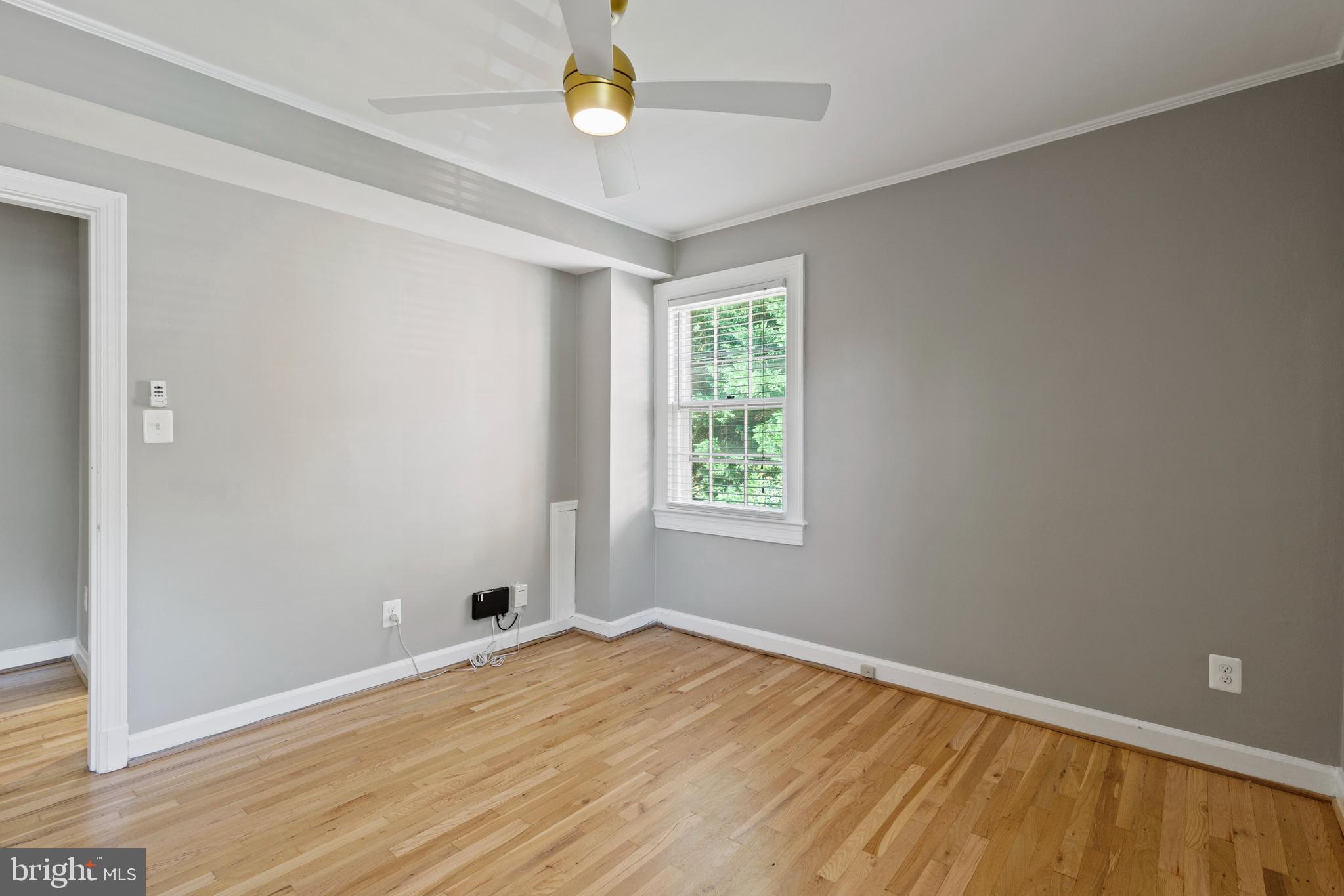 1300 South Cleveland Street, Unit 363 Arlington, VA 22204 - Photo 28 of 37 an empty room with wooden floor and windows