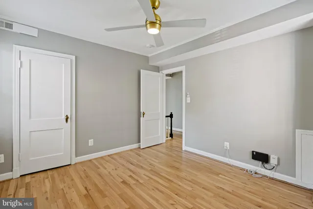a view of an empty room with wooden floor