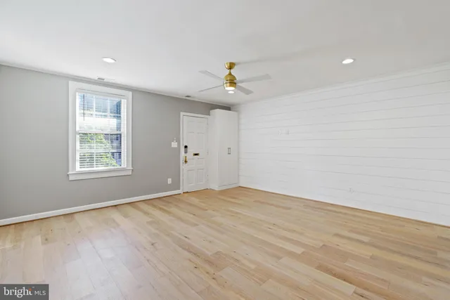 wooden floor in an empty room with a window