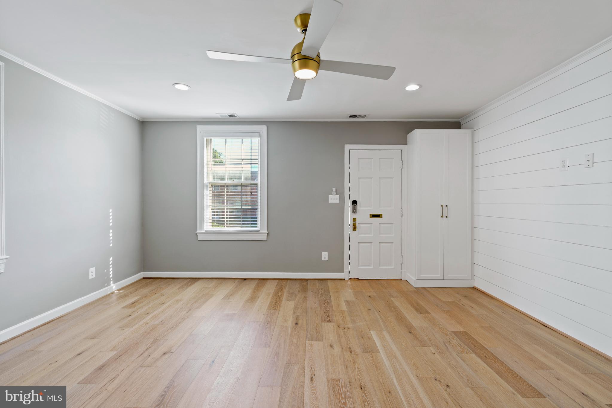 1300 South Cleveland Street, Unit 363 Arlington, VA 22204 - Photo 9 of 37 a view of an empty room with wooden floor and window