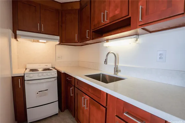 a kitchen with stainless steel appliances granite countertop a sink and a stove