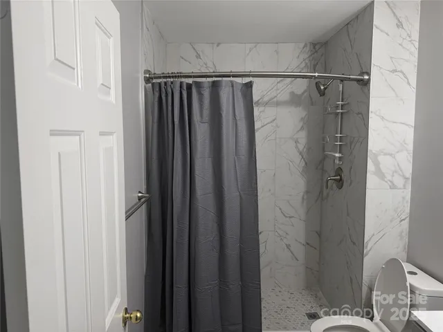 a bathroom with a shower and a sink