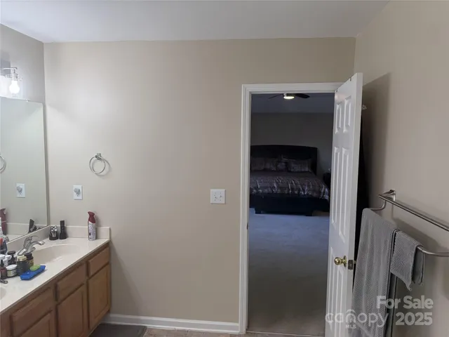 a en suite bathroom with a sink and a mirror