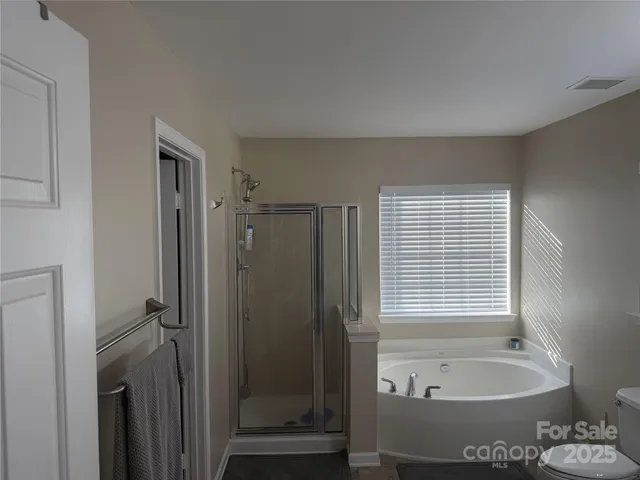 a bathroom with a tub shower and sink
