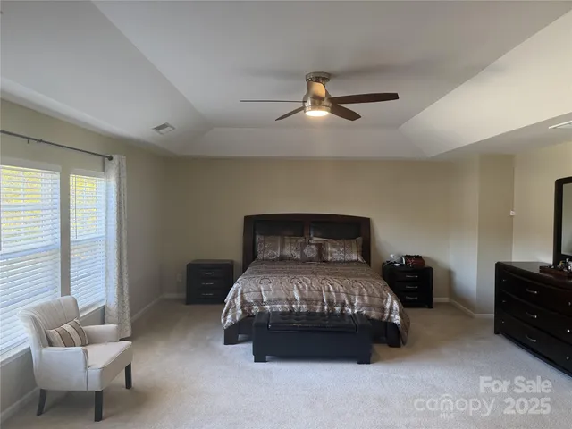 a bedroom with a bed and a couch