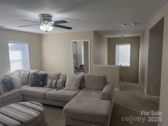 a living room with furniture and a chandelier