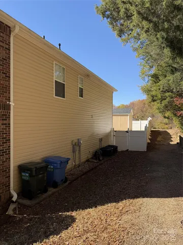 a view of backyard of house and car parked