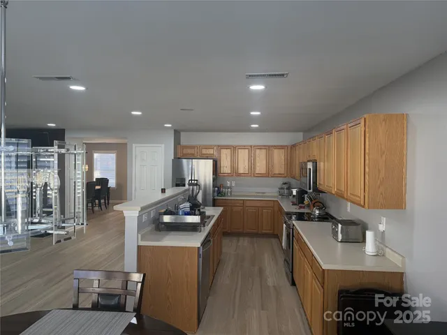 a kitchen with a sink appliances and cabinets