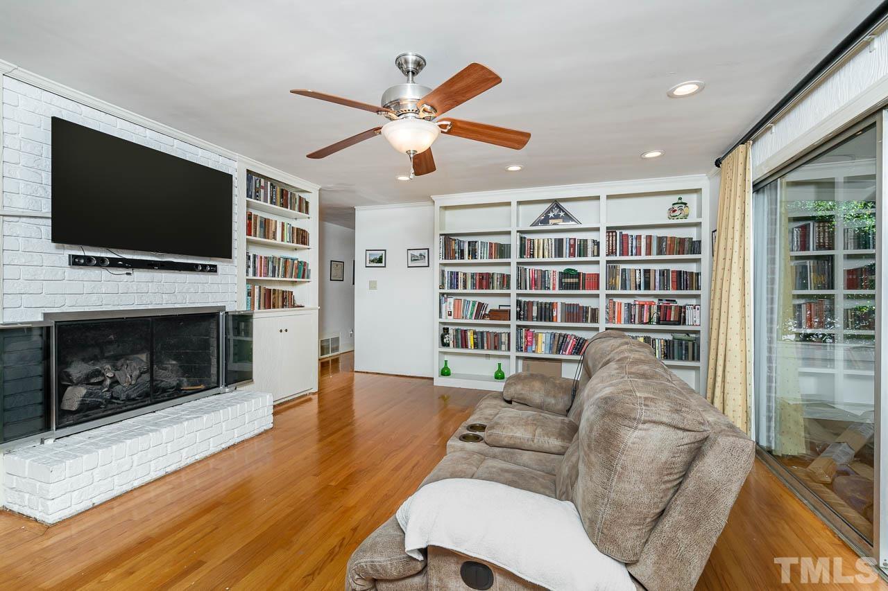 1221 Dixie Trail Raleigh, NC 27607 - Photo 13 of 26 a living room with furniture a flat screen tv and a fireplace