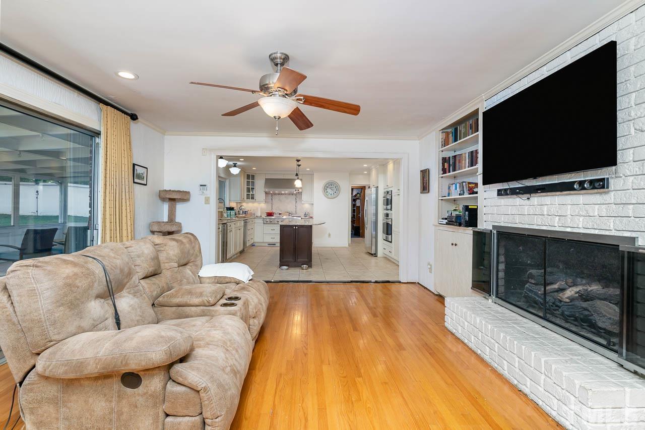 1221 Dixie Trail Raleigh, NC 27607 - Photo 14 of 26 a living room with furniture a flat screen tv and a fireplace