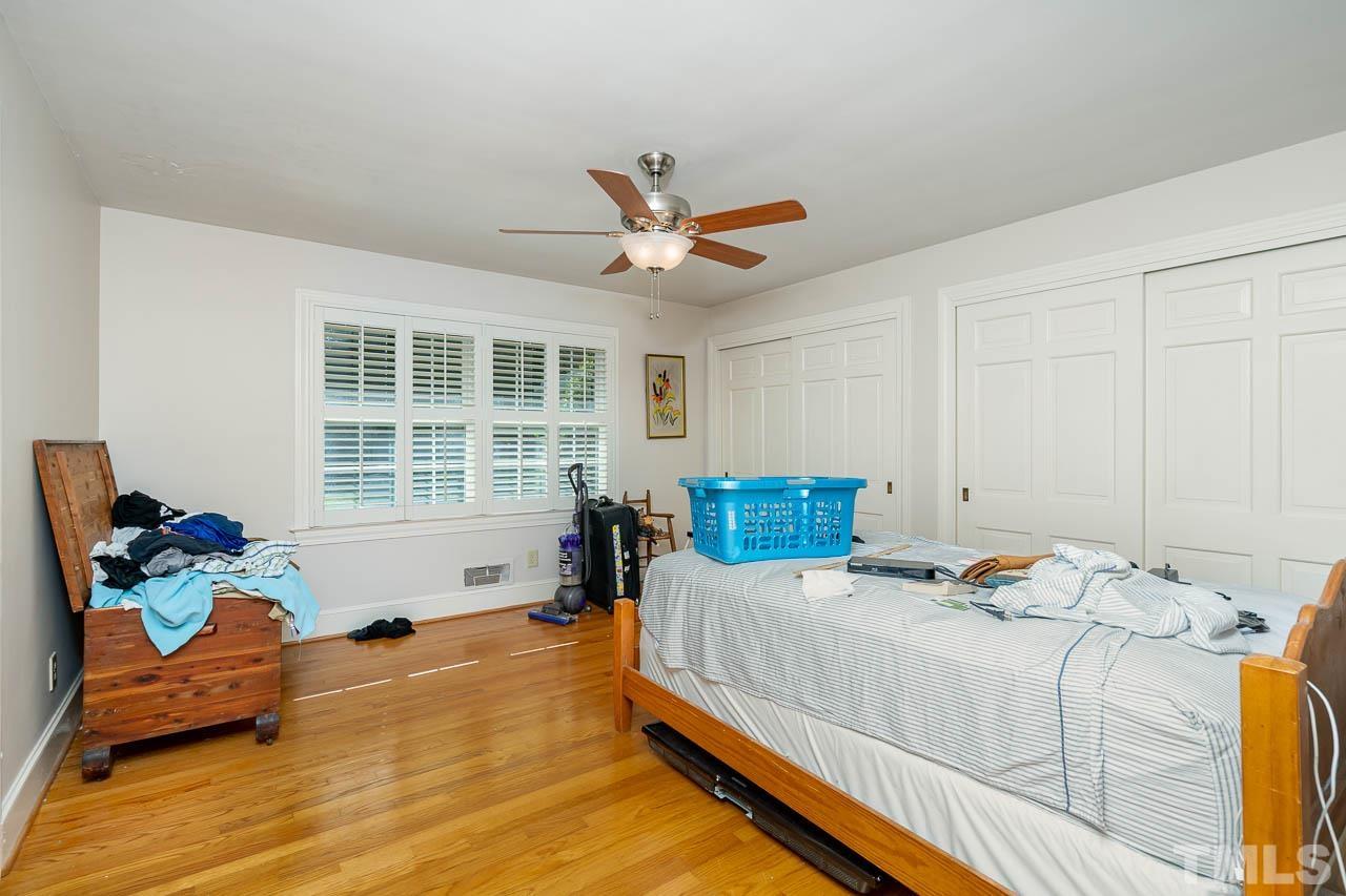 1221 Dixie Trail Raleigh, NC 27607 - Photo 15 of 26 a bedroom with a bed and glass window