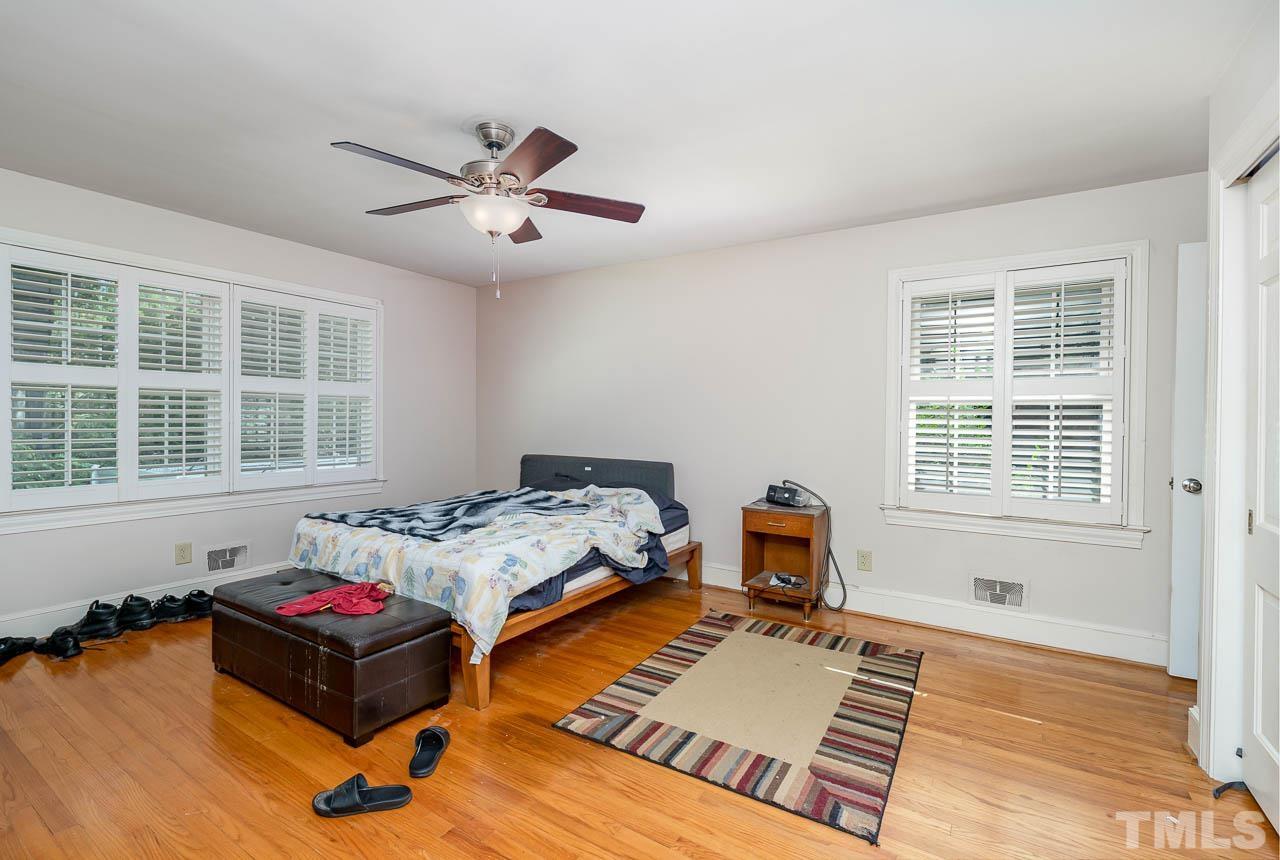1221 Dixie Trail Raleigh, NC 27607 - Photo 20 of 26 a bedroom with a bed and wooden floor