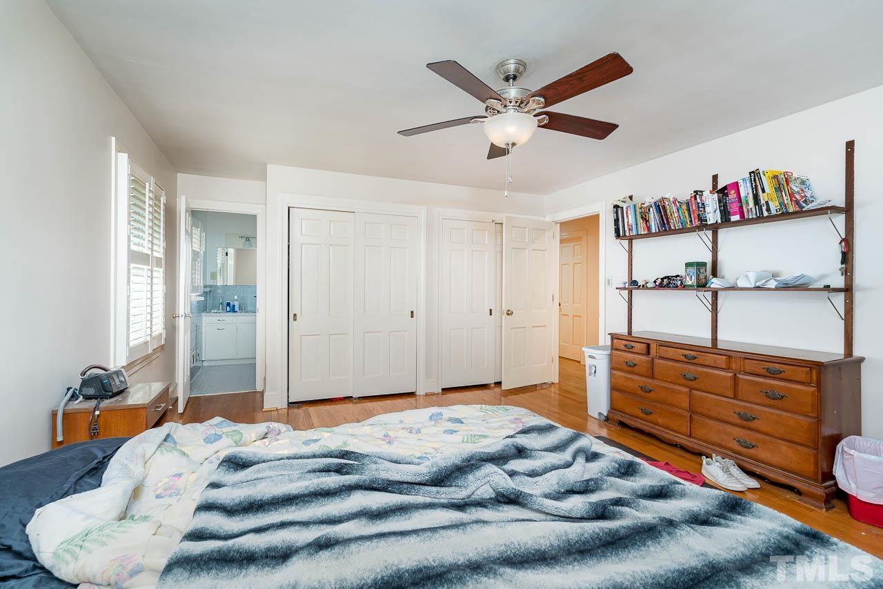 1221 Dixie Trail Raleigh, NC 27607 - Photo 21 of 26 a bedroom with a bed and a chandelier