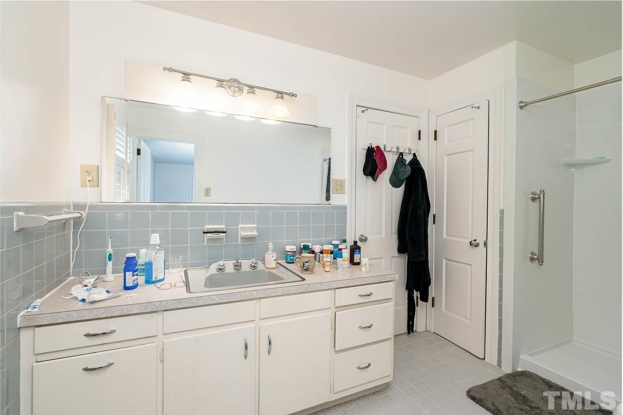 1221 Dixie Trail Raleigh, NC 27607 - Photo 22 of 26 a bathroom with a sink double vanity and a mirror