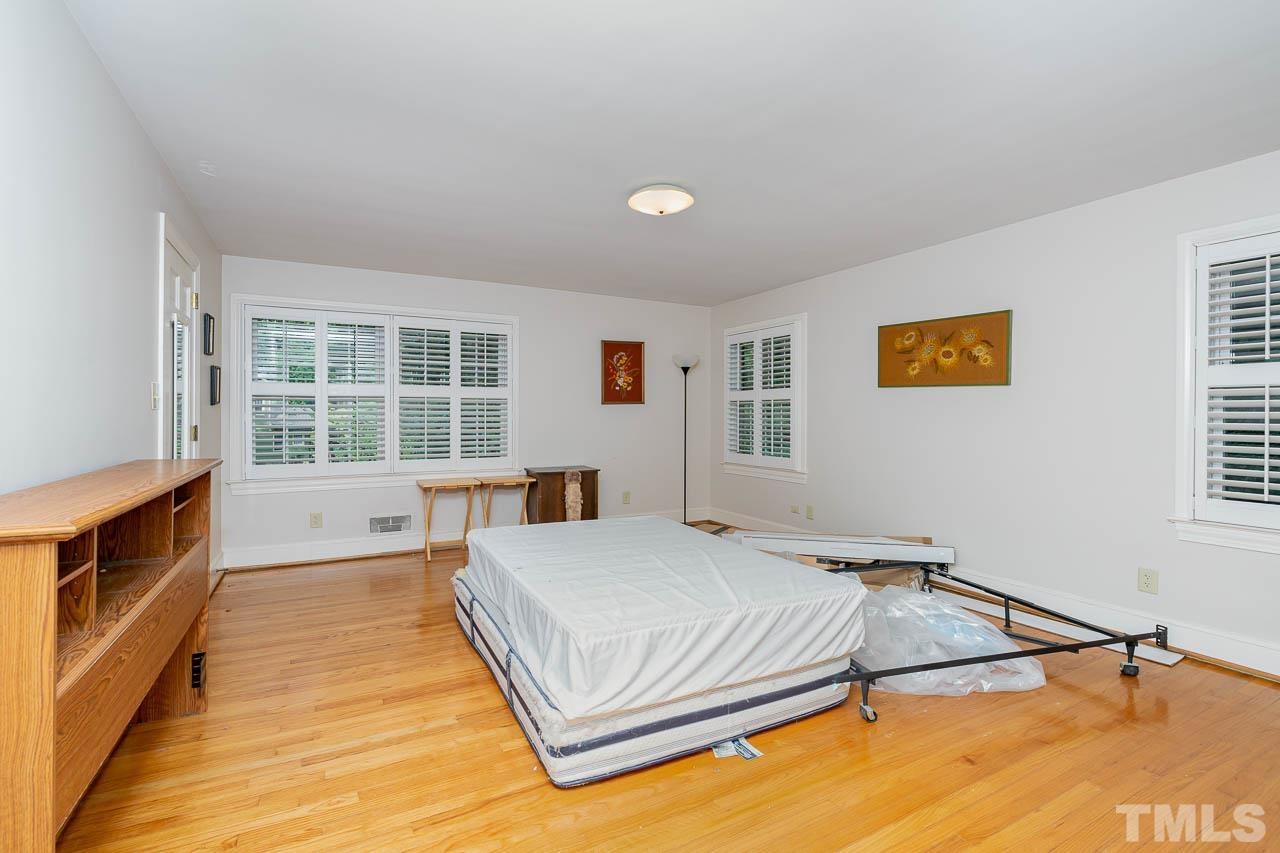 1221 Dixie Trail Raleigh, NC 27607 - Photo 23 of 26 a bedroom with a bed and window