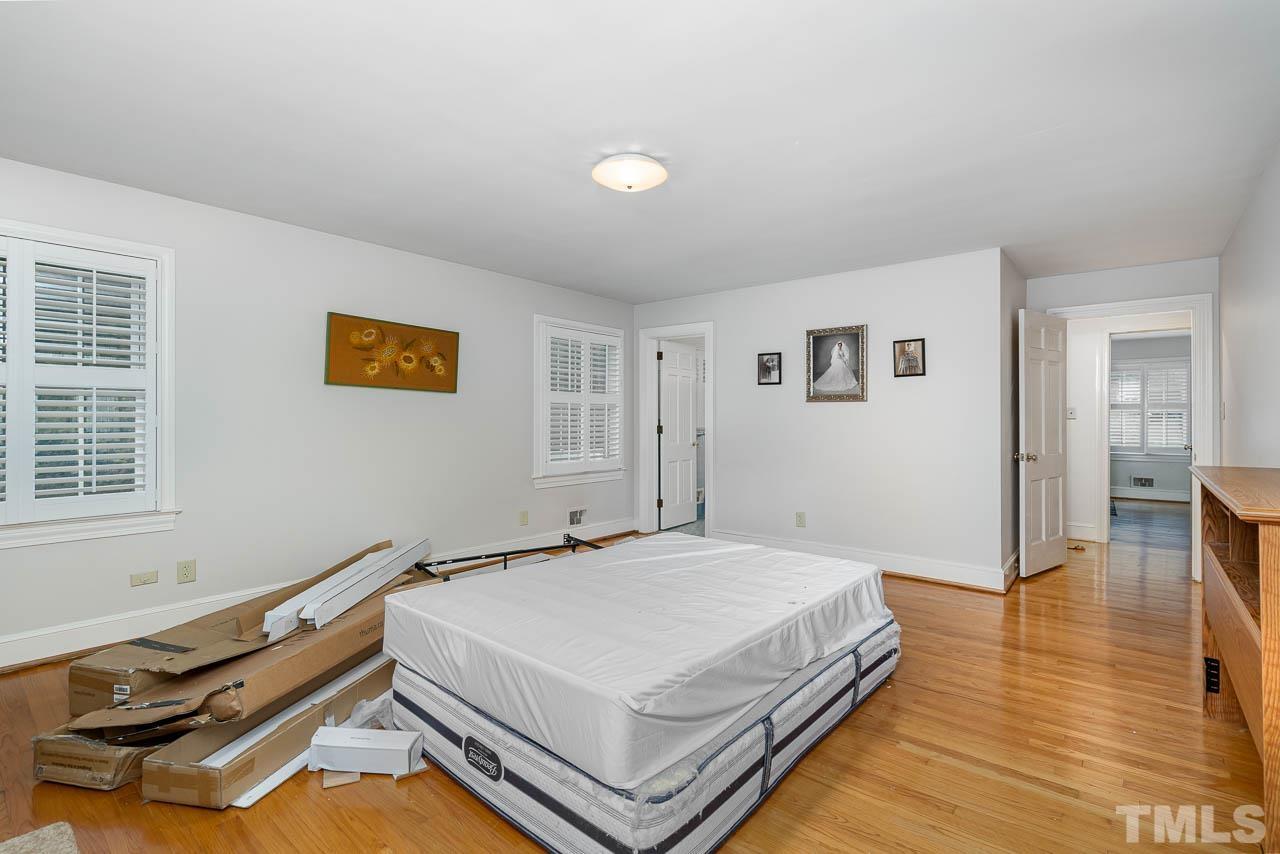 1221 Dixie Trail Raleigh, NC 27607 - Photo 24 of 26 a bedroom with a bed and wooden floor