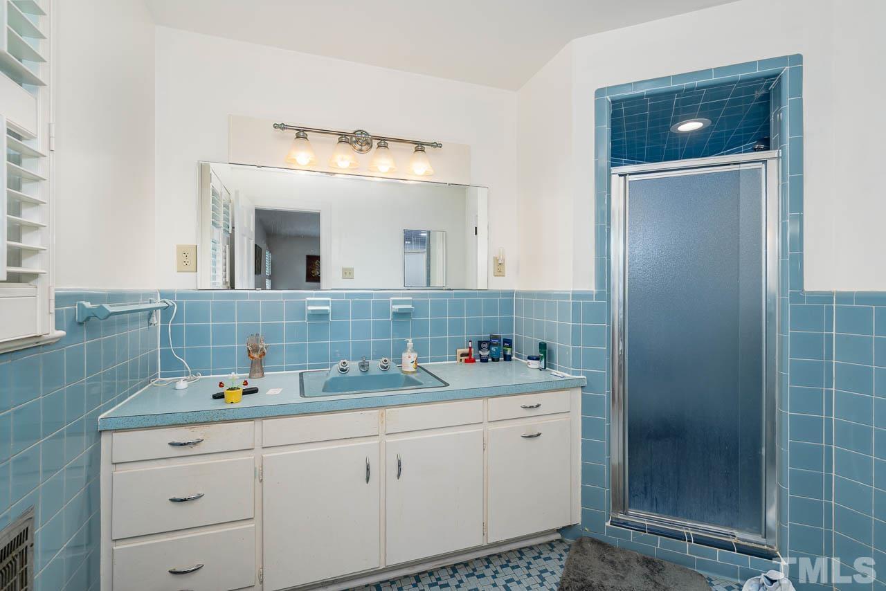 1221 Dixie Trail Raleigh, NC 27607 - Photo 25 of 26 a bathroom with a sink and a mirror