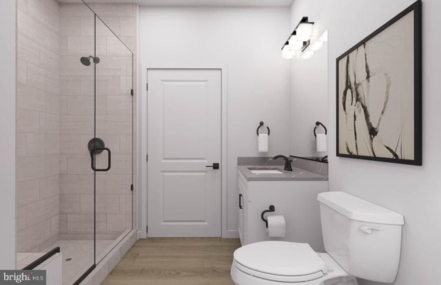 a bathroom with a toilet sink and shower