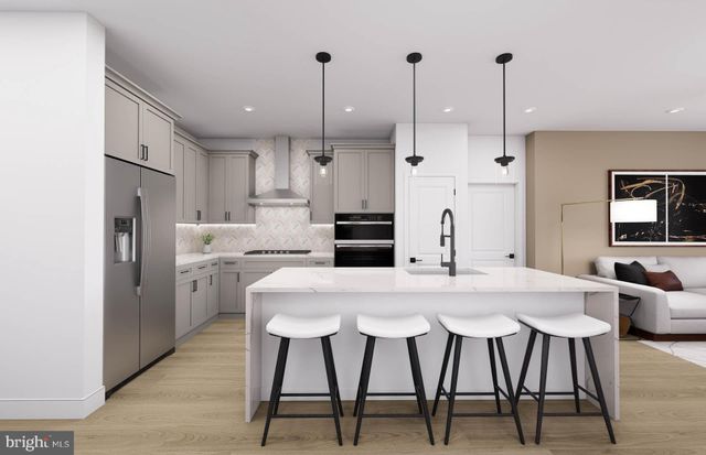 a kitchen with refrigerator a oven and chairs