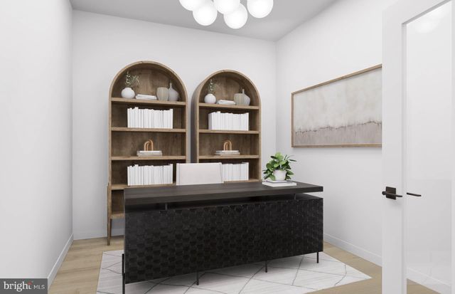 a room with a table and paintings on the wall