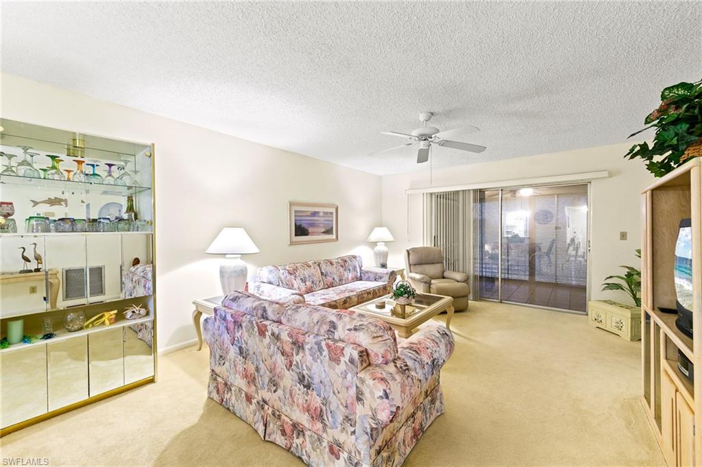 5467 Rattlesnake Hammock Road, Unit 302C Naples, FL 34113 - Photo 14 of 29 Living area with sliders to lanai