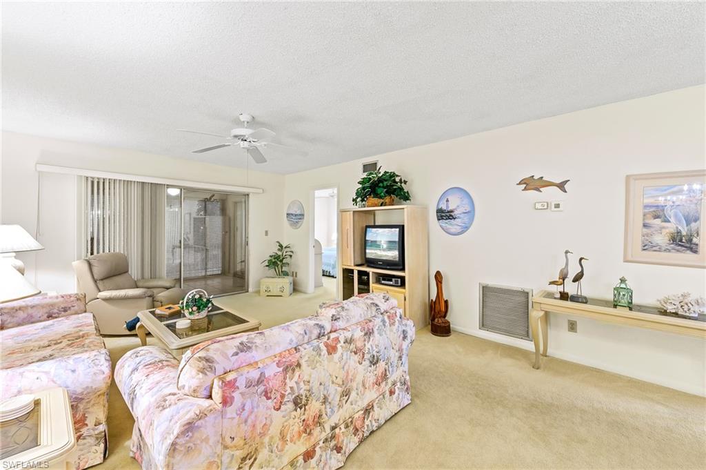 5467 Rattlesnake Hammock Road, Unit 302C Naples, FL 34113 - Photo 15 of 29 Great room with sliders to lanai