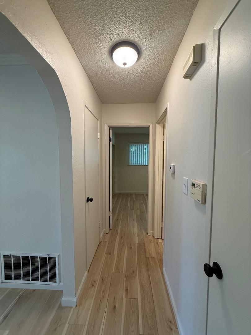 2505 Prescott Road, Unit 1 Modesto, CA 95350 - Photo 30 of 42 a view of a hallway with wooden floor