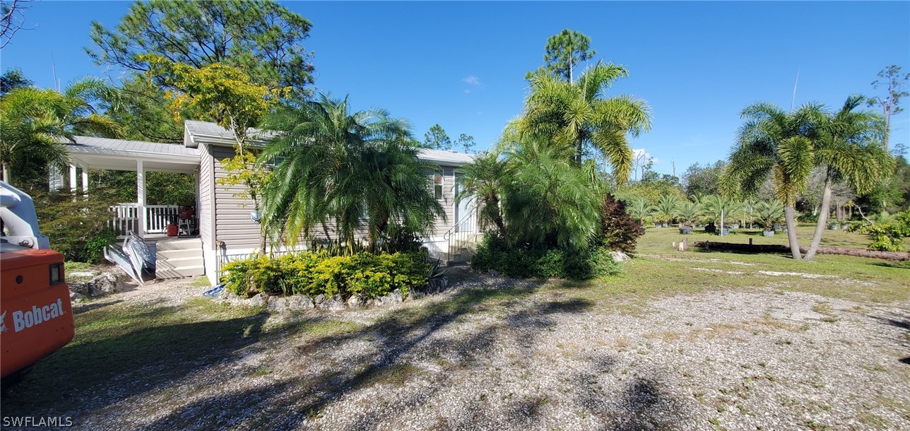 20500 Corkscrew Road Estero, FL 33928 - Photo 3 of 12 a view of backyard of house with outdoor seating and green space