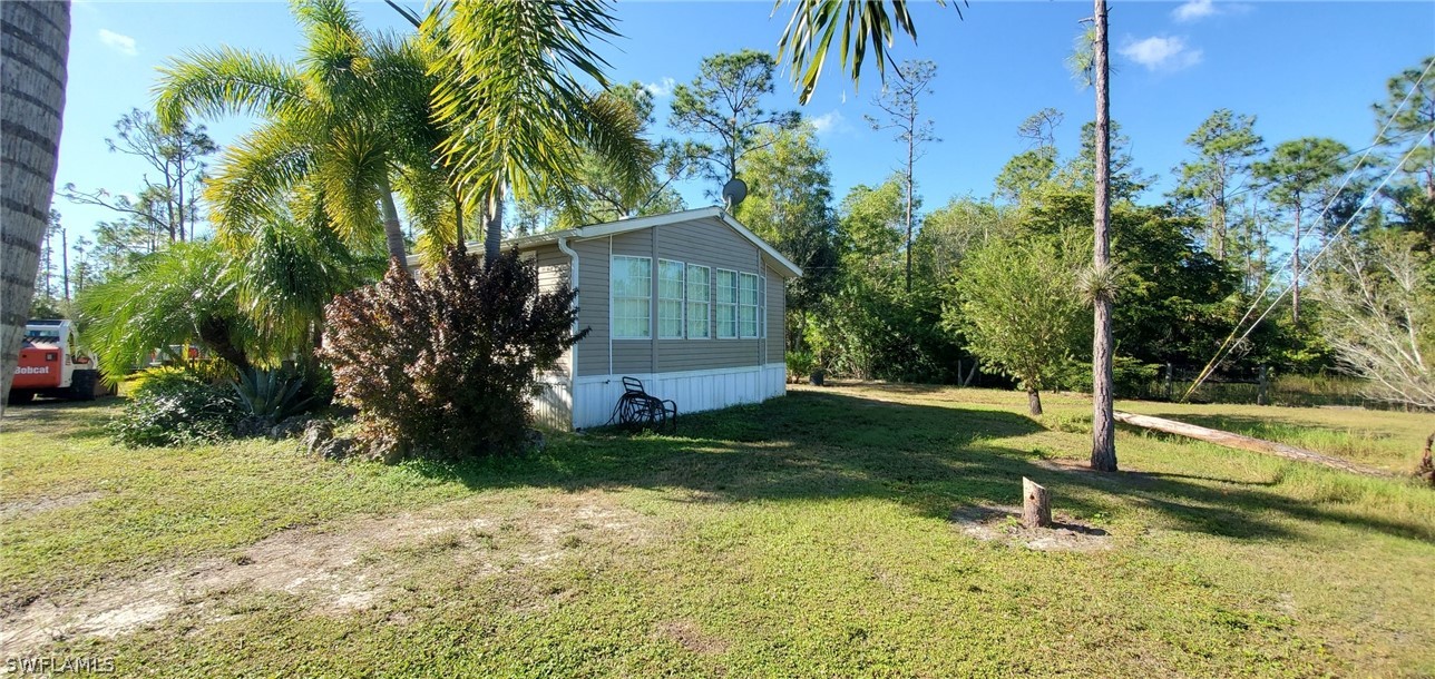 20500 Corkscrew Road Estero, FL 33928 - Photo 4 of 12 a house with a tree in front of it