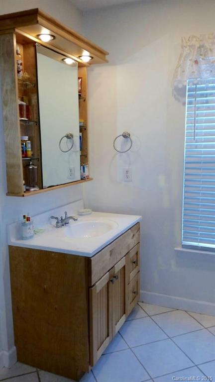 203 Williams Road Wingate, NC 28174 - Photo 4 of 5 a bathroom with a sink and a mirror