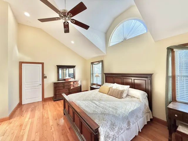 a bedroom with a bed and wooden floor