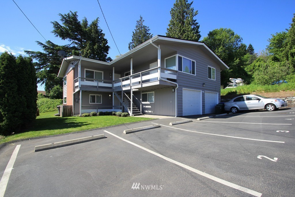 81 Southwest 2nd Street Renton, WA 98057 - Photo 1 of 22 a front view of a house with a yard and trees