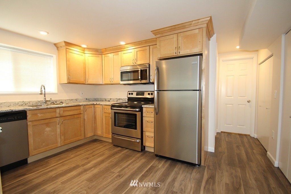 81 Southwest 2nd Street Renton, WA 98057 - Photo 11 of 22 a kitchen with a refrigerator wooden floor and a sink