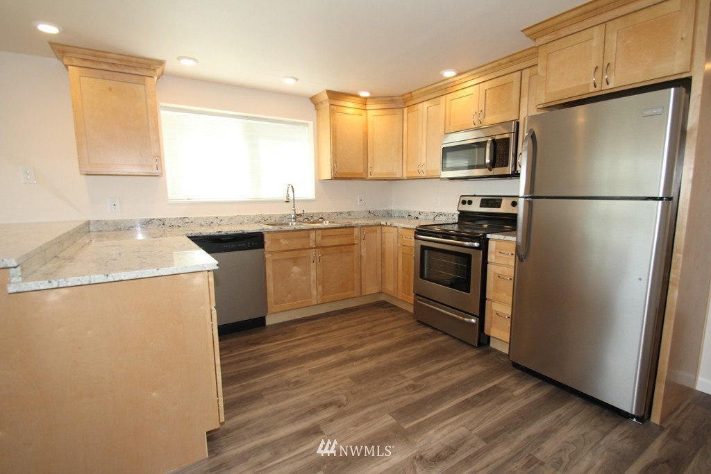 81 Southwest 2nd Street Renton, WA 98057 - Photo 12 of 22 a kitchen with stainless steel appliances granite countertop a refrigerator a stove a sink and a microwave