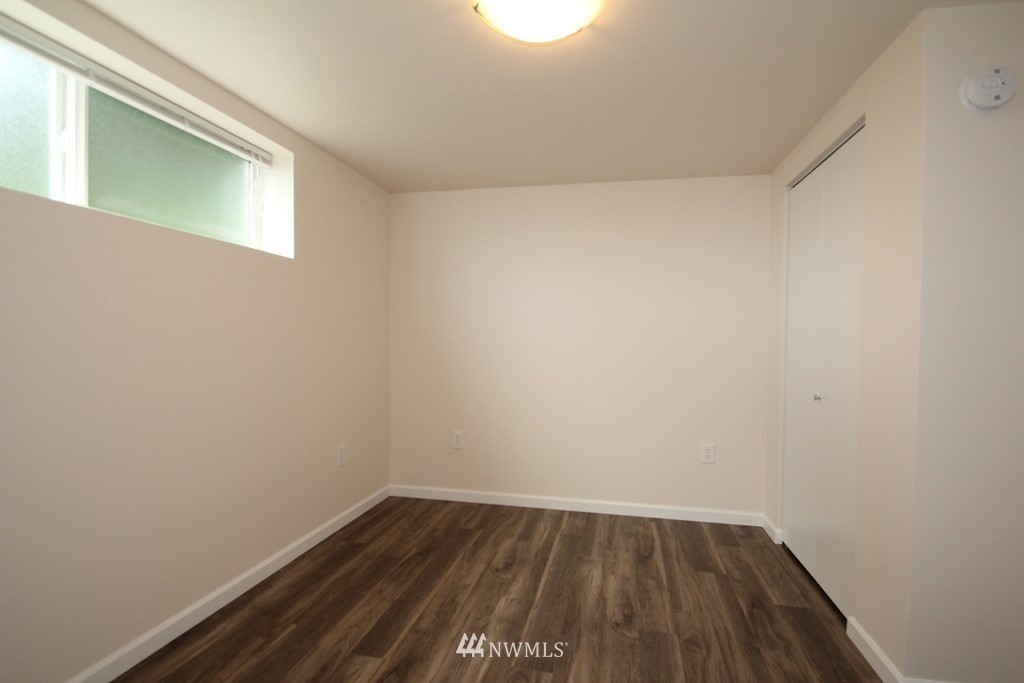 81 Southwest 2nd Street Renton, WA 98057 - Photo 13 of 22 a view of an empty room with wooden floor and a window