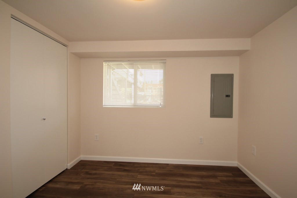 81 Southwest 2nd Street Renton, WA 98057 - Photo 15 of 22 an empty room with wooden floor and windows