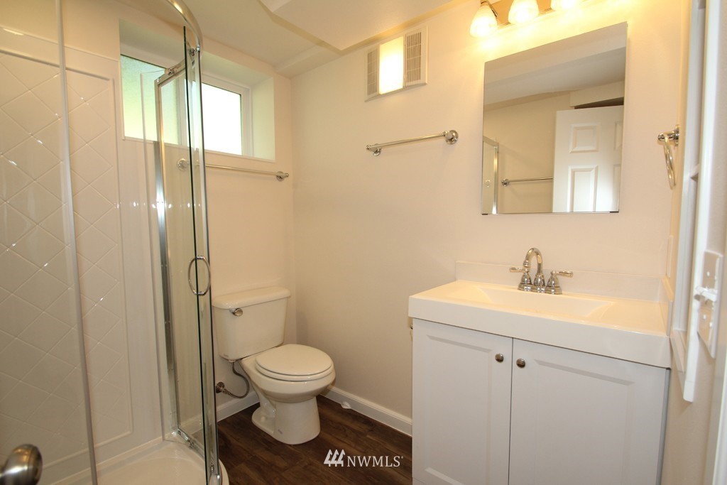 81 Southwest 2nd Street Renton, WA 98057 - Photo 16 of 22 a bathroom with a toilet a sink and a mirror