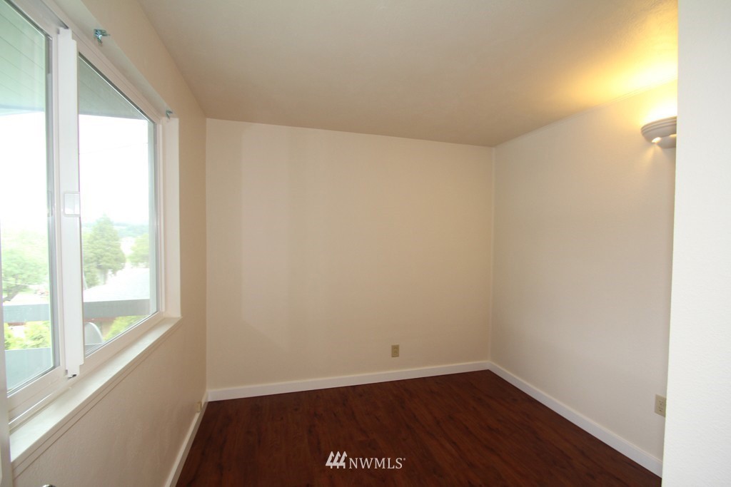 81 Southwest 2nd Street Renton, WA 98057 - Photo 17 of 22 a view of a small space with wooden floor and a window