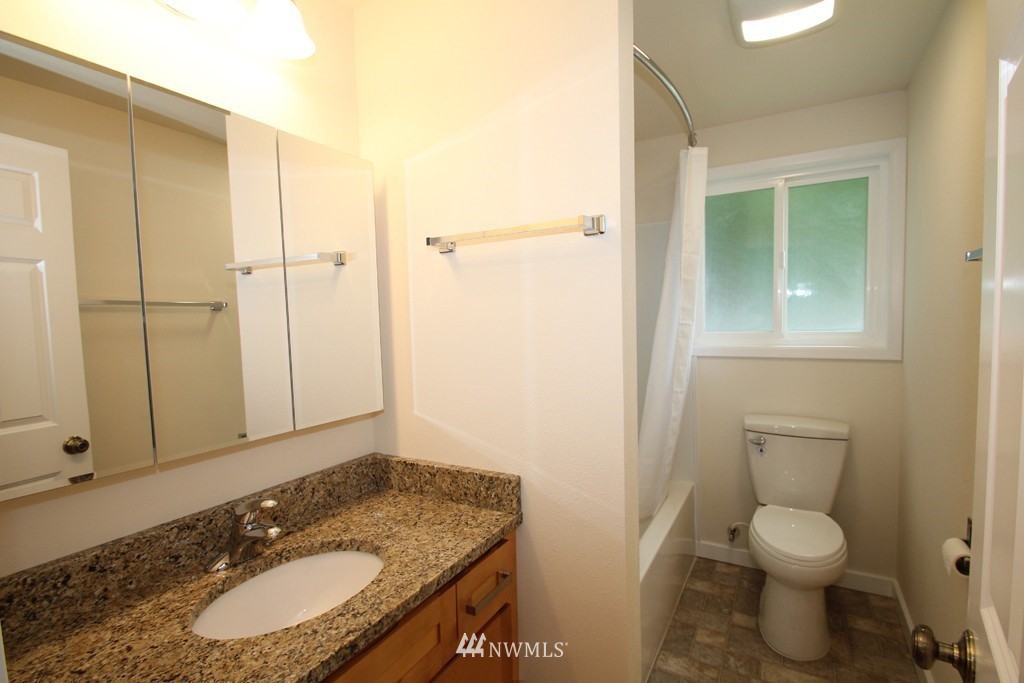 81 Southwest 2nd Street Renton, WA 98057 - Photo 18 of 22 a bathroom with a granite countertop sink toilet and shower