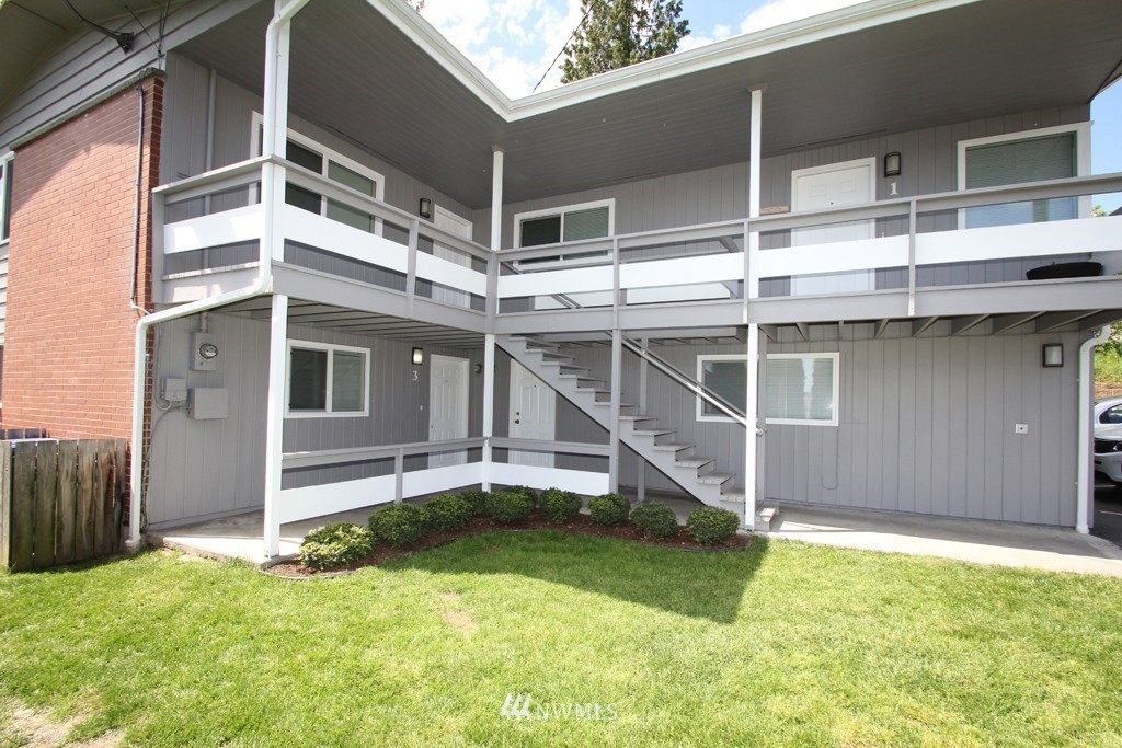 81 Southwest 2nd Street Renton, WA 98057 - Photo 2 of 22 a view of a backyard with wooden fence and a large tree
