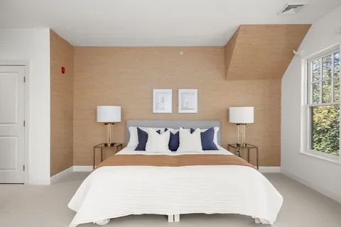 a bedroom with a large bed and a couch