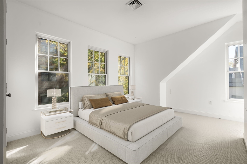 125 Crowninshield Road, Unit 125 Brookline, MA 02446 - Photo 20 of 22 a bedroom with a bed and a window